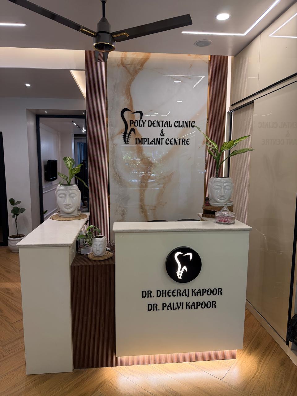 Reception desk at Poly Dental Clinic Mohali with Dr. Dheeraj Kapoor and Dr. Palvi Kapoor branding